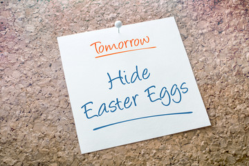 Hide Easter Eggs Reminder For Tomorrow On Paper Pinned On Cork Board