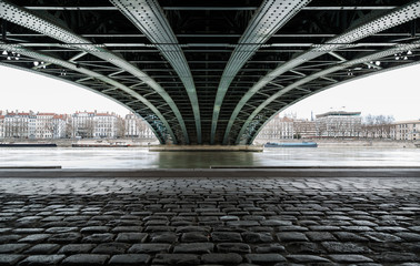 Empty street under a bridge in Lyon on a winter day.