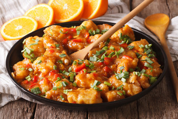 Chicken in sweet and sour orange sauce closeup. Horizontal
