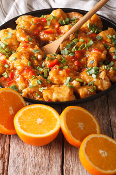 Delicious orange chicken fillets close-up on the table. vertical
