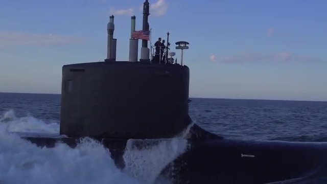Excellent aerials over a submarine at sea.