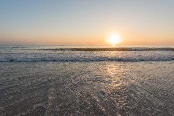 Sunshine with water splash at the tropical beach