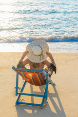 Girl on a tropical beach with hat