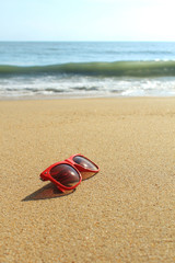 Red sunglasses on the beach
