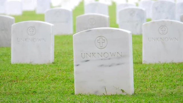 Many headstones on graves of unknown soldiers in US national military cemetery