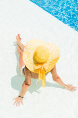 A girl is relaxing in a swimming pool