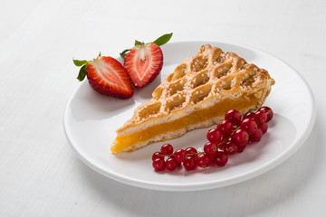 apple pie slice on white plate with fruits