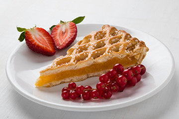 apple pie slice on white plate with fruits