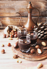Hot chocolate in a glass cup with nuts and cinnamon