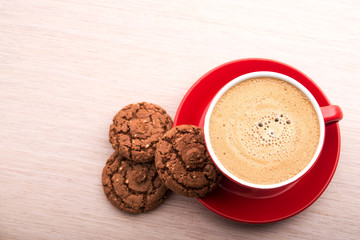 Coffee cup with chocolate cookies on kitchen table