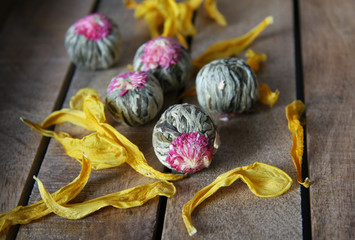 Flowering tea balls on a wooden tray 2