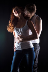 Woman with red hair and hugging man