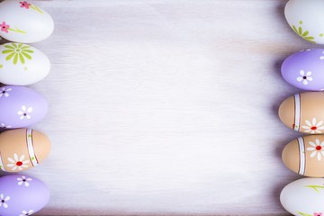 Pastel colors Easter eggs on a grey wooden background.
