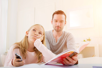 Father helping out her daughter for homework