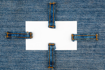 Business card with four straps  jeans, lies on the denim