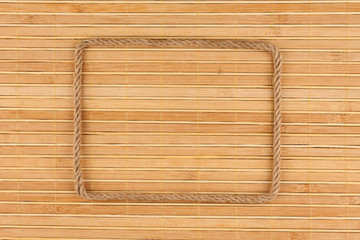 Frame of rope, lies on a background of a  bamboo mat