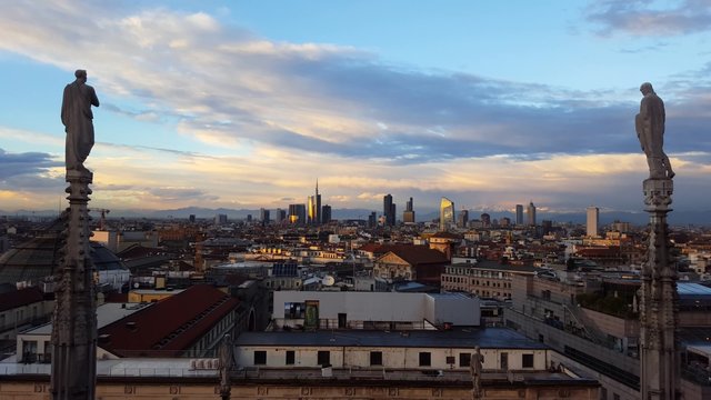 Aerial panoramic view of Milan skyline at sunset with office bilding and apartment