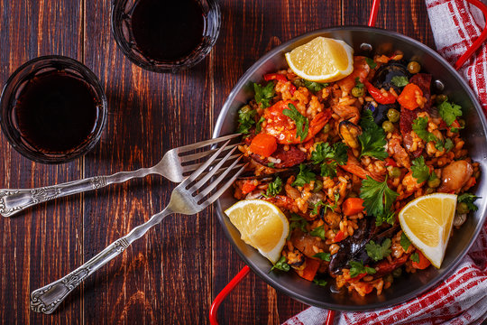 Paella with chicken, chorizo, seafood, vegetables and saffron se