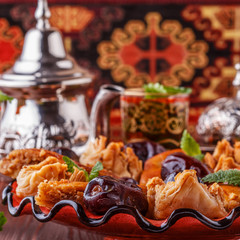Moroccan mint tea in the traditional glasses with sweets.