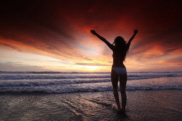 Fototapeta na wymiar Woman on the beach at sunset