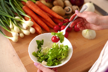 Young Woman Cooking in the kitchen. Healthy Food