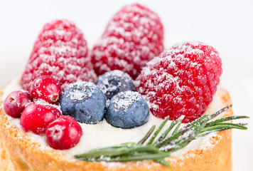 closeup cake with fresh raspberries, blueberries and cranberries