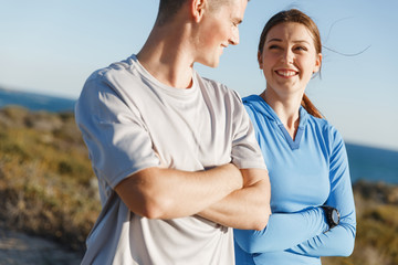 Young couple on beach training together