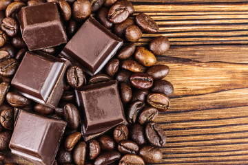 Dark chocolate cubes and roasted coffee beans, top view
