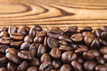Roasted coffee bean arabica on wooden table, close-up, selective focus