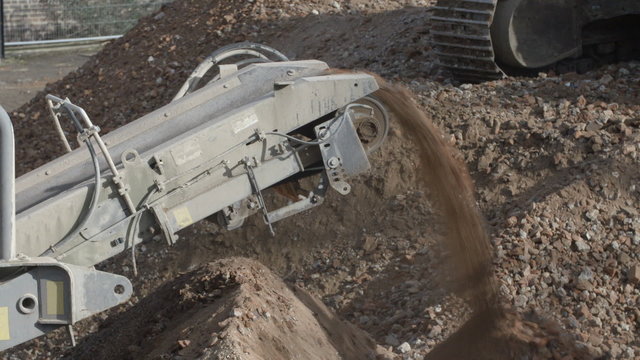 A screening machine on a construction site, separating soil from rubble after demolition.