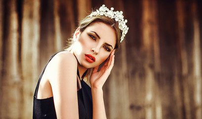 Beautiful girl model blonde summer outdoors in the crown. Red lips, manicure, smoky eyes. photo...