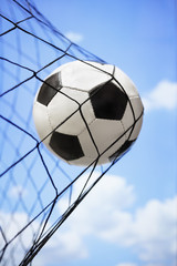 Soccer ball in back of the goal net