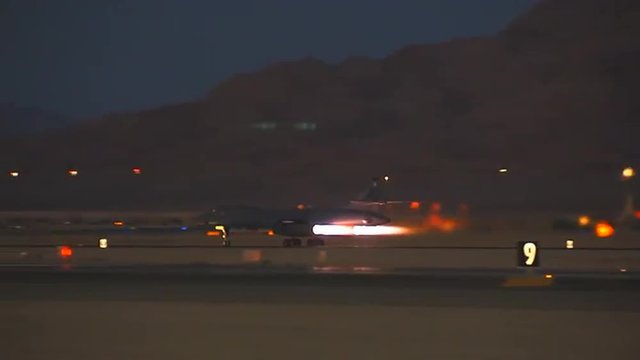 Air Force B-1 Lancer taking off at night.