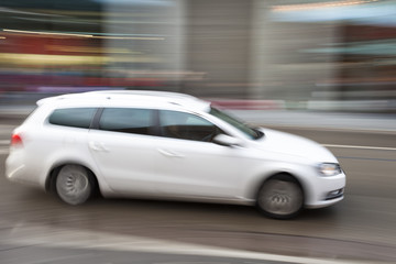 Car in motion blur, car driving fast in city