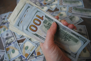 Woman hand hold cash dollar banknotes. Only hundreds.