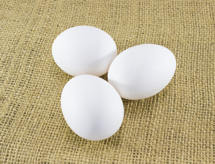 Three eggs on sacking