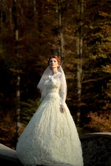 Obraz na płótnie Canvas Elegant pensive bride outdoor