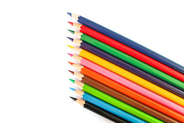 many colorful pencil crayons over a white background