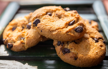 Chocolate chip cookies place on the bamboo plate, selective focu
