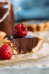 Mini pastry tartlets with chocolate, on old paper 