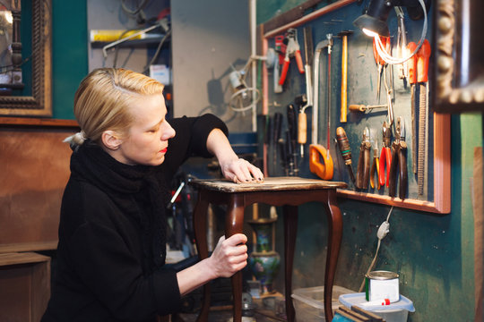 woman restoring table