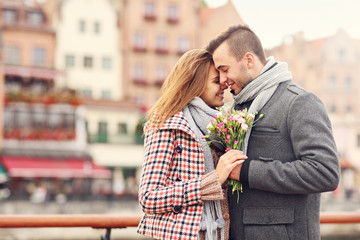Romantic couple with flowers in the city