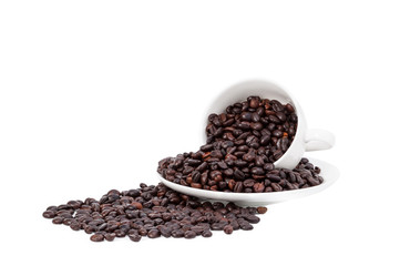 Spilled coffee beans from coffee mug isolated on white background