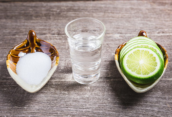 Shot glass with lemon and salt on the wood table