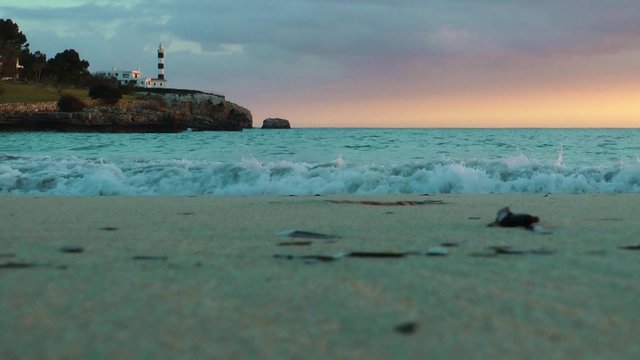 Majorca, Portocolom, beach in evening light with lighthouse