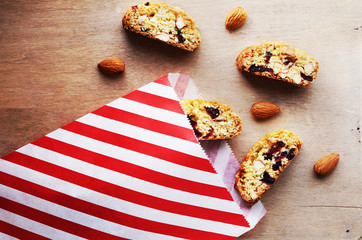 Biscotti with almond and dried cranberries in paper bag