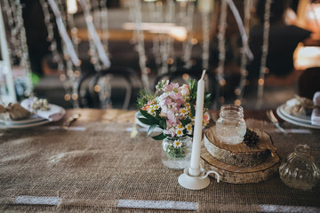 decorations made of wood and wildflowers served on the festive table