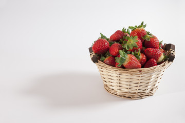 Strawberries in a basket on a white background