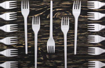 plastic forks on wooden background