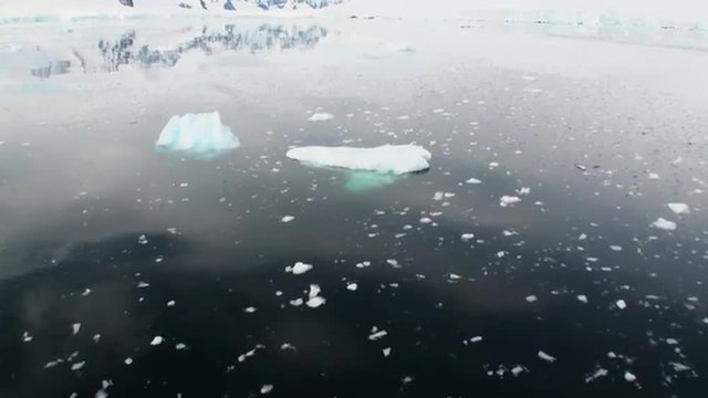 Ice and small icebergs floats on the ocean surface in the Antarctica. Amazing beautiful views of Nature and landscape of snow, ice and white of Antarctic. Global Warming.